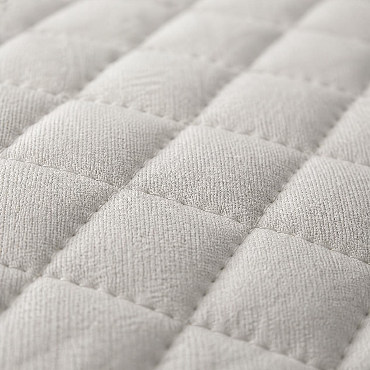Macro close up of the quilted cover fabric showing the stitch pattern and weave