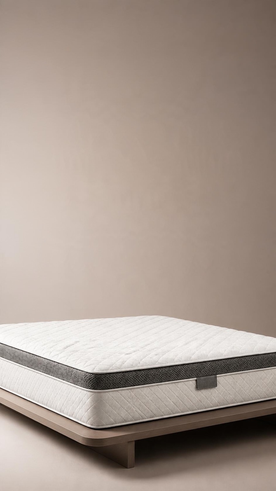Vertical ad composition with the mattress low in frame and empty warm gradient space above